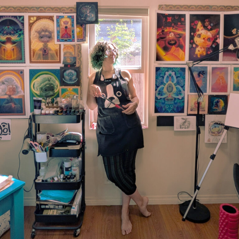 Artist Graciela Goncalves Da Silva (Animalitoland) in her vibrant studio, surrounded by her colorful, stylized paintings, holding a paintbrush and looking thoughtfully towards natural light.
