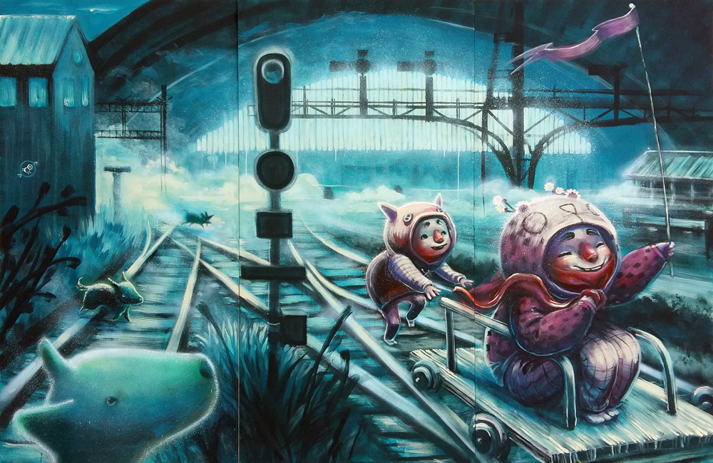 A whimsical, stylized painting by Animalitoland titled "Memorias de las vías." Two rosy-cheeked, animal-like characters ride a small wooden cart on a train track. The character in front, wearing a deep purple outfit with a hood and ears, sits on the cart, holding a flag. Behind them, a smaller character in a similar outfit pushes the cart. The scene is set on a series of merging train tracks, under a large, arched structure, with a blue, dreamlike atmosphere. A shadowy, ghost-like figure of a dog is visible in the foreground to the left.